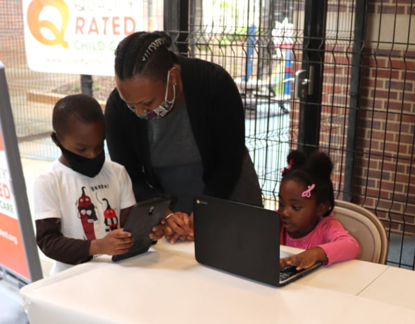 Atlanta Children's Shelter student look at new tablets and Chromebooks